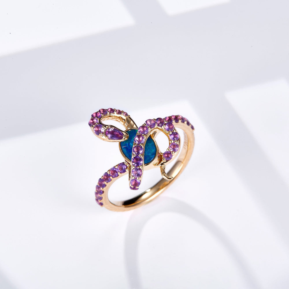 18K gold ring featuring an oval Australian opal with a snake design set in yellow gold, adorned with natural amethyst gemstones for a vibrant contrast.